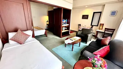 a hotel room with a bed and a living room at RJ Service Suite at Times Square in Kuala Lumpur
