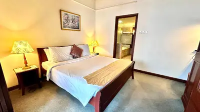 a bedroom with a bed and a lamp and a mirror at RJ Service Suite at Times Square in Kuala Lumpur