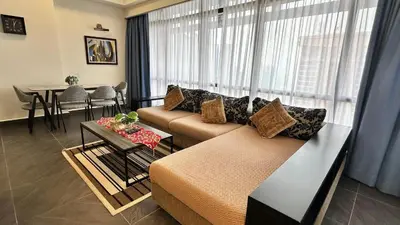 a living room with a couch and a table at Rihanna service suite at times square in Kuala Lumpur