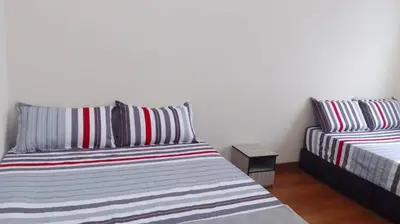 a bedroom with a bed and a night stand next to it at VUE RESIDENCES SERVICE SUITE 2 ROOMS DELUXE 6 Pax in Kuala Lumpur