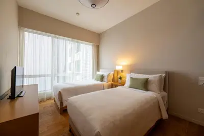 a hotel room with two beds and a window at Lanson Place Bukit Ceylon in Kuala Lumpur