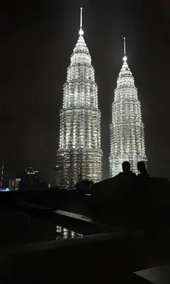 two large towers are lit up at night at Like Home Star KLCC in Kuala Lumpur