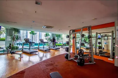 a gym with several tread machines in a room at Deluxe Swiss Garden Residences Bukit Bintang City Center in Kuala Lumpur
