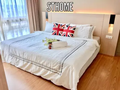 a bedroom with a large white bed with flowers on it at Deluxe Swiss Garden Residences Bukit Bintang City Center in Kuala Lumpur