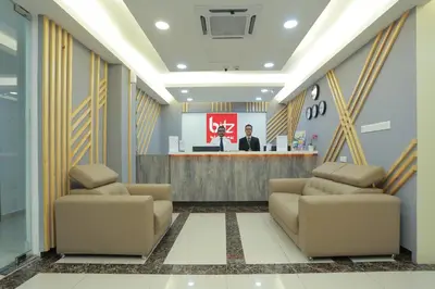 a lobby with two couches in front of a counter at Bitz Bintang Hotel in Kuala Lumpur