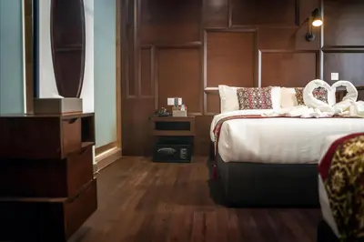 a hotel room with a bed with two white rings on it at East Riverine Boutique Hotel in Kuala Lumpur