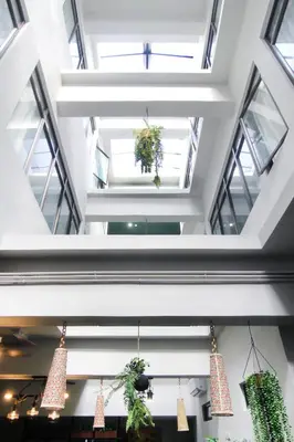 a room with windows and plants on the ceilings at East Riverine Boutique Hotel in Kuala Lumpur