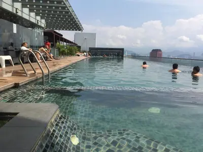 a swimming pool with people in the water at Regalia Skypool KLCC in Kuala Lumpur