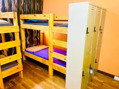 a room with two bunk beds and a locker at Regalia Skypool KLCC in Kuala Lumpur