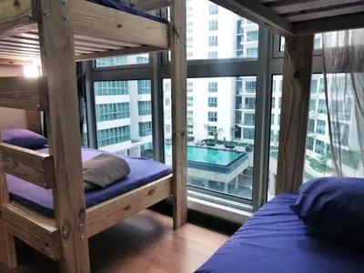 a bedroom with bunk beds and a view of a pool at Regalia Skypool KLCC in Kuala Lumpur