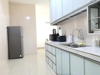 a kitchen with a sink and a refrigerator at Rafflesia Condominium by Dahlia Homes in Kuala Lumpur