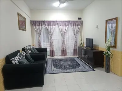 a living room with a couch and a television at UMMII Homestay in Ampang
