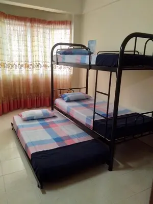 two bunk beds in a room with a window at UMMII Homestay in Ampang