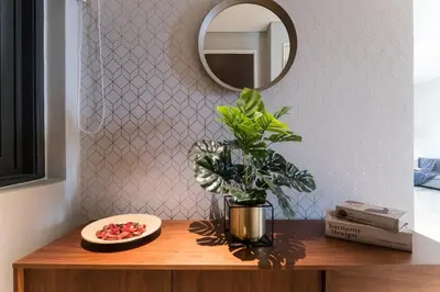 a table with a potted plant and a mirror at TriBeCa 2bedroom 3min walk to bukit bintang 2 rooftop pool in Kuala Lumpur