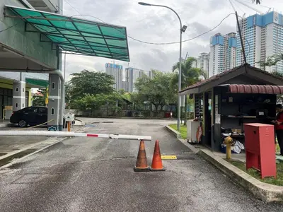 a gas station with two orange cones in the street at Mahasa Homestay Kuala Lumpur in Kuala Lumpur