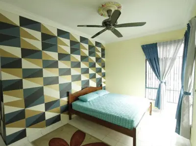 a bedroom with a bed and a ceiling fan at Mahasa Homestay Kuala Lumpur in Kuala Lumpur