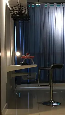 a room with a chair and a blue curtain at Cozy Studio 10min to KLCC next to Hospital Gleneagle Jalan Ampang in Kuala Lumpur
