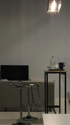 a table and chairs in a room with a light at Cozy Studio 10min to KLCC next to Hospital Gleneagle Jalan Ampang in Kuala Lumpur