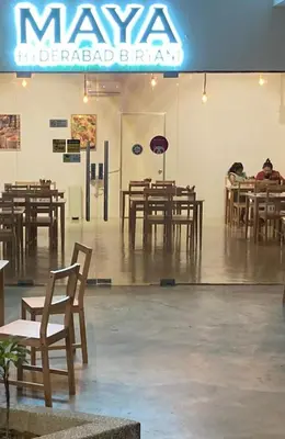 a restaurant with wooden tables and wooden chairs at Cozy Studio 10min to KLCC next to Hospital Gleneagle Jalan Ampang in Kuala Lumpur