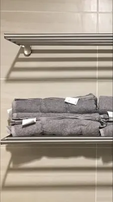 a shelf with four gray towels on it at 3 Towers 10min to KLCC next to Hospital Gleneagle in Kuala Lumpur