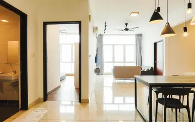 a kitchen and a living room with a table and chairs at Boulevard Service Apartment KL by Airhost in Kuala Lumpur