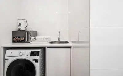 a kitchen with a washing machine and a sink at Arte Plus Jalan Ampang by Airhost in Kuala Lumpur
