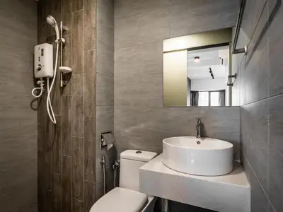 a bathroom with a sink and a toilet and a mirror at Arte Plus Jalan Ampang by Airhost in Kuala Lumpur