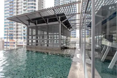 a building with a pool of water in front of it at Rex Ollie @ The Elements Ampang in Kuala Lumpur