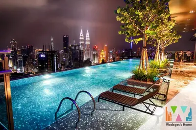 a swimming pool on top of a building with a city skyline at KLCC Expressionz by WGS in Kuala Lumpur
