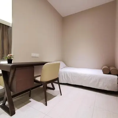 a bedroom with a desk and a bed and a chair at Sky Pool Elegant Suite @ Sri Hartamas in Kuala Lumpur