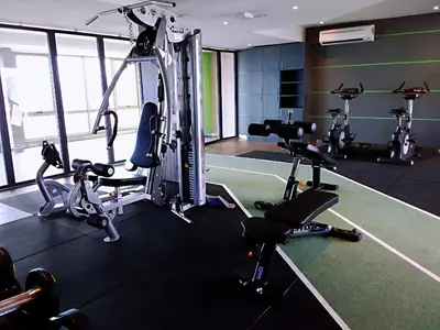 a gym with several tread machines in a room at Sky Pool Elegant Suite @ Sri Hartamas in Kuala Lumpur