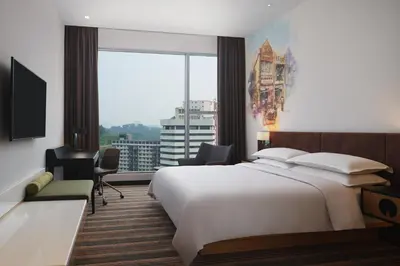 a bedroom with a large bed and a large window at Four Points by Sheraton Kuala Lumpur, Chinatown in Kuala Lumpur