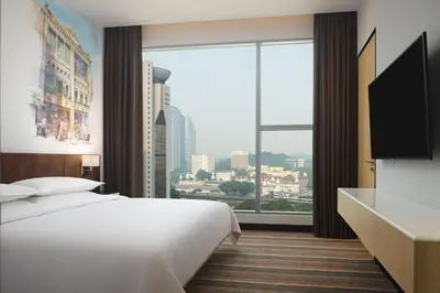 a hotel room with a bed and a large window at Four Points by Sheraton Kuala Lumpur, Chinatown in Kuala Lumpur
