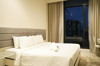 a hotel room with a bed and a window at ExpressionZ Suites KLCC in Kuala Lumpur