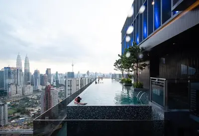 a swimming pool on the roof of a building with a city at ExpressionZ Suites KLCC in Kuala Lumpur