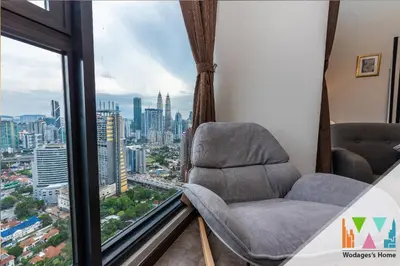 two chairs in a room with a view of a city at KLCC View Expressionz Family Loft by WGS in Kuala Lumpur