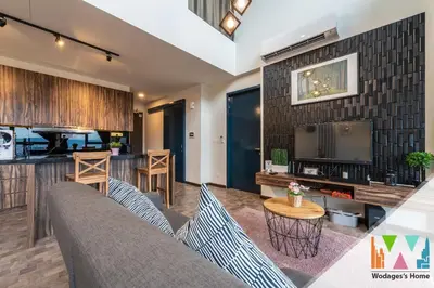 a living room with a couch and a table at KLCC View Expressionz Family Loft by WGS in Kuala Lumpur