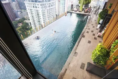 a pool with people swimming in it in a city at Ceylonz Suites by MyKey in Kuala Lumpur