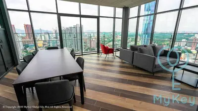 a room with a table and chairs in a building with windows at Ceylonz Suites by MyKey in Kuala Lumpur
