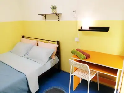 a small bedroom with a bed and a desk at Coffee & Tea Homestay 2 in Kuala Lumpur