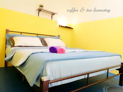 a bed with two pink pillows on top of it at Coffee & Tea Homestay 2 in Kuala Lumpur