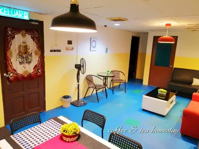 a living room with a table and chairs at Coffee & Tea Homestay 2 in Kuala Lumpur