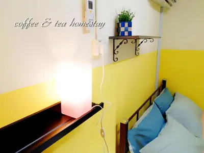 a bedroom with a bed with a light on it at Coffee & Tea Homestay 2 in Kuala Lumpur