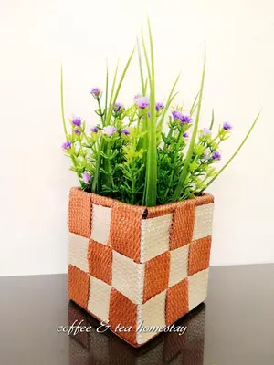 a flower basket with flowers in it on a table at Coffee & Tea Homestay 2 in Kuala Lumpur