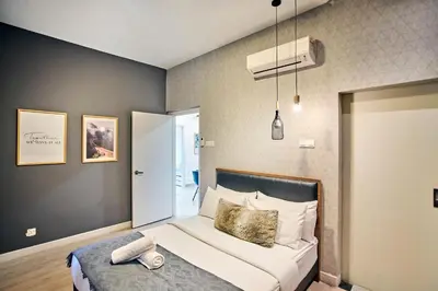 a bedroom with a bed and a air conditioner at Arte Plus KLCC Designer Suites by Cobnb in Kuala Lumpur