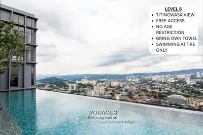 a swimming pool with a view of a city at WGS Suites at KLCC in Kuala Lumpur