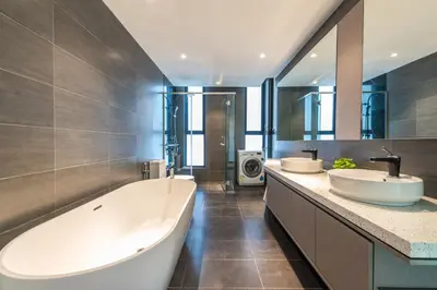 a bathroom with two sinks and a large tub at WGS Suites at KLCC in Kuala Lumpur