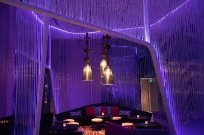 a purple room with a couch and some lights at Tropicana The Residences KLCC by Vale Pine in Kuala Lumpur