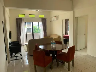 a living room with a dining room table and chairs at Akar Hotel Kampung Baru in Kuala Lumpur
