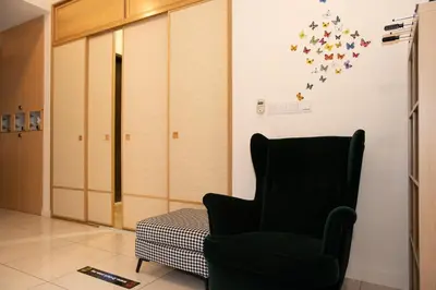 a room with a chair and stars on the wall at Kisetsu no ie, KLCC Kuala Lumpur in Kuala Lumpur